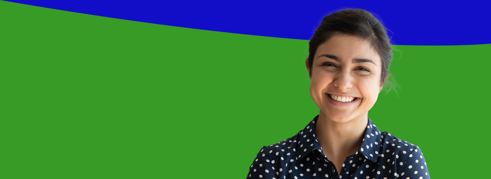 The image shows a person smiling at the camera, standing against a purple background.