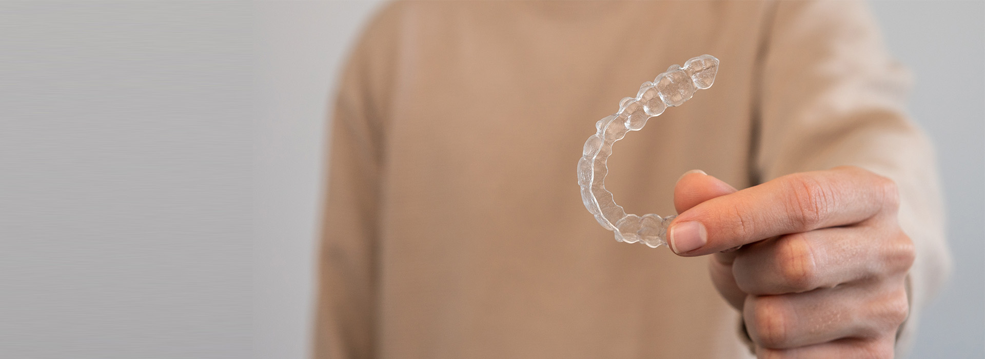 A person s hand holding a transparent soap bubble.